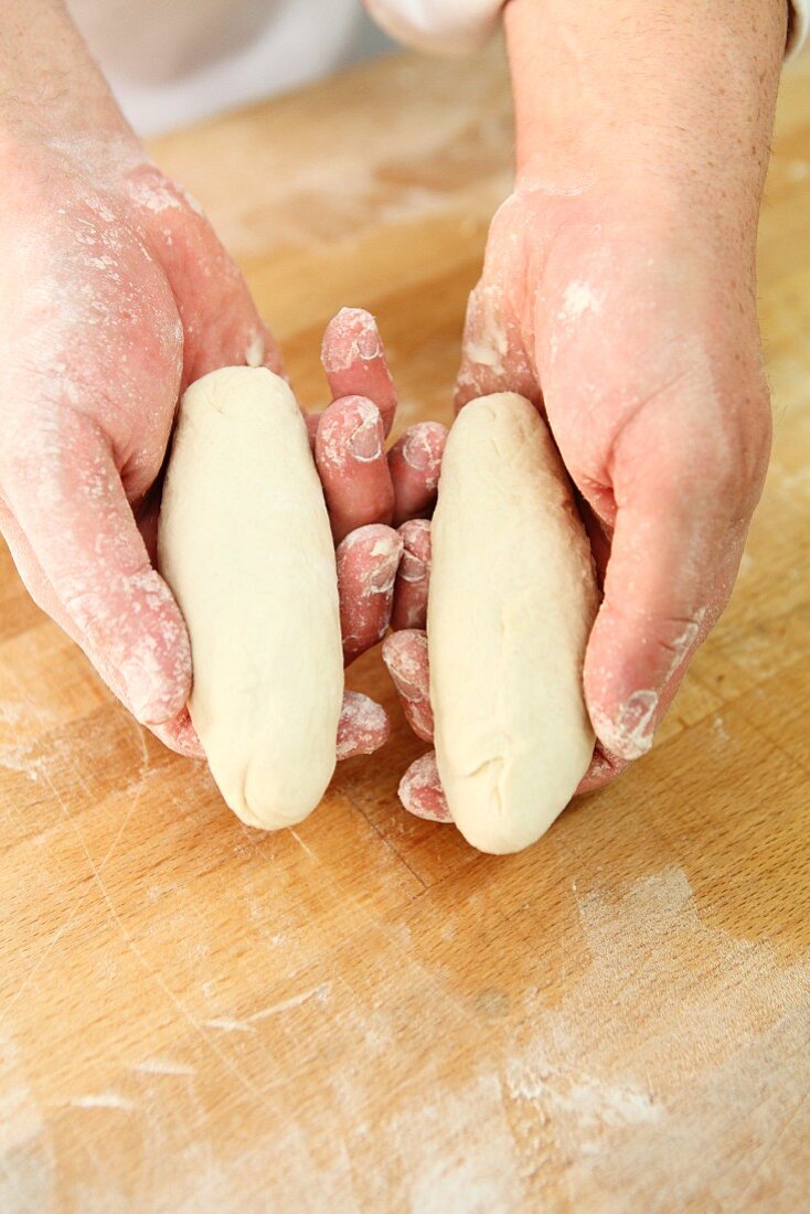 Dough being shaped into long fingers