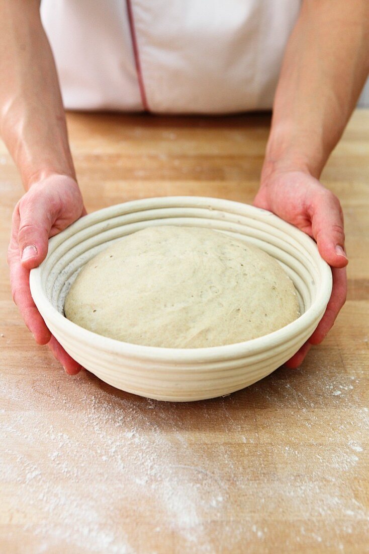 Dough being left to rise in a proofing basket (direct fermentation)