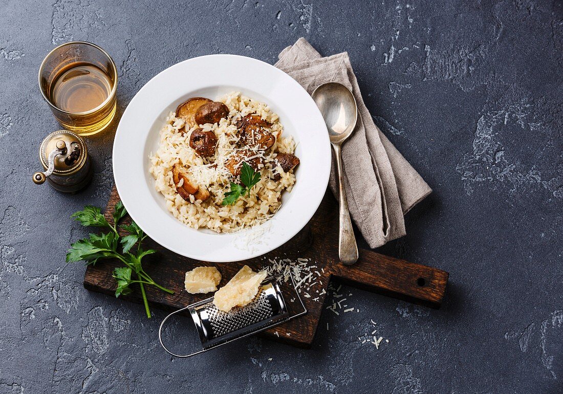 Risotto with porcini mushrooms on dark stone background