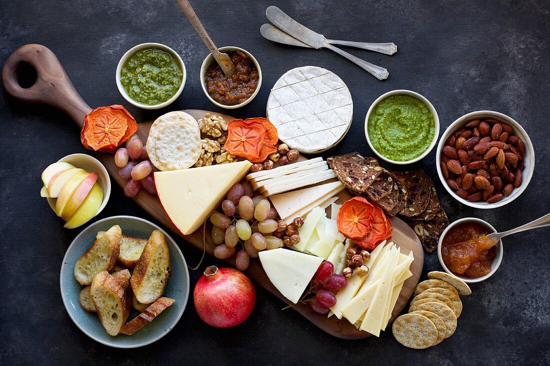A cheese board of various cheese and crackers