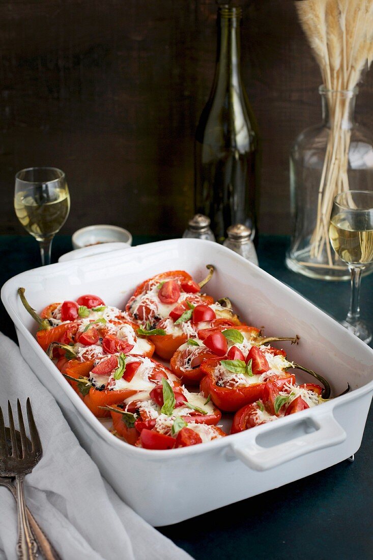 Black Rice Caprese Stuffed Roasted Red Peppers served with a fresh Basil Oil and white wine
