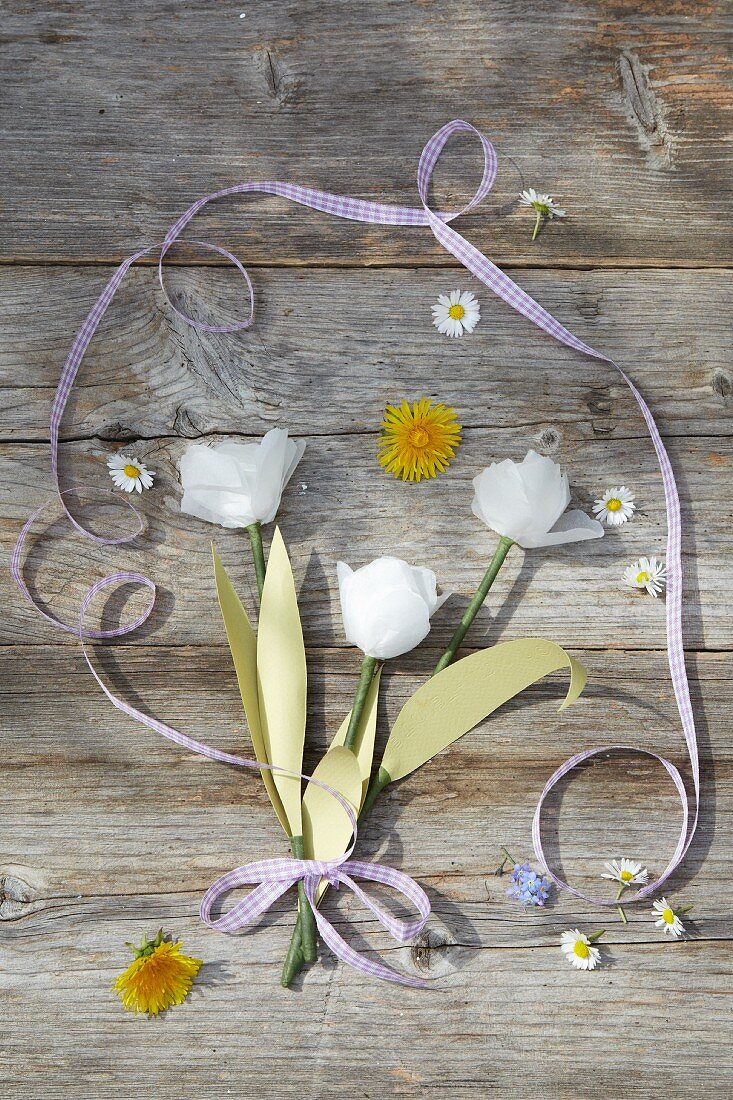 Paper tulips and flowers on wooden boards