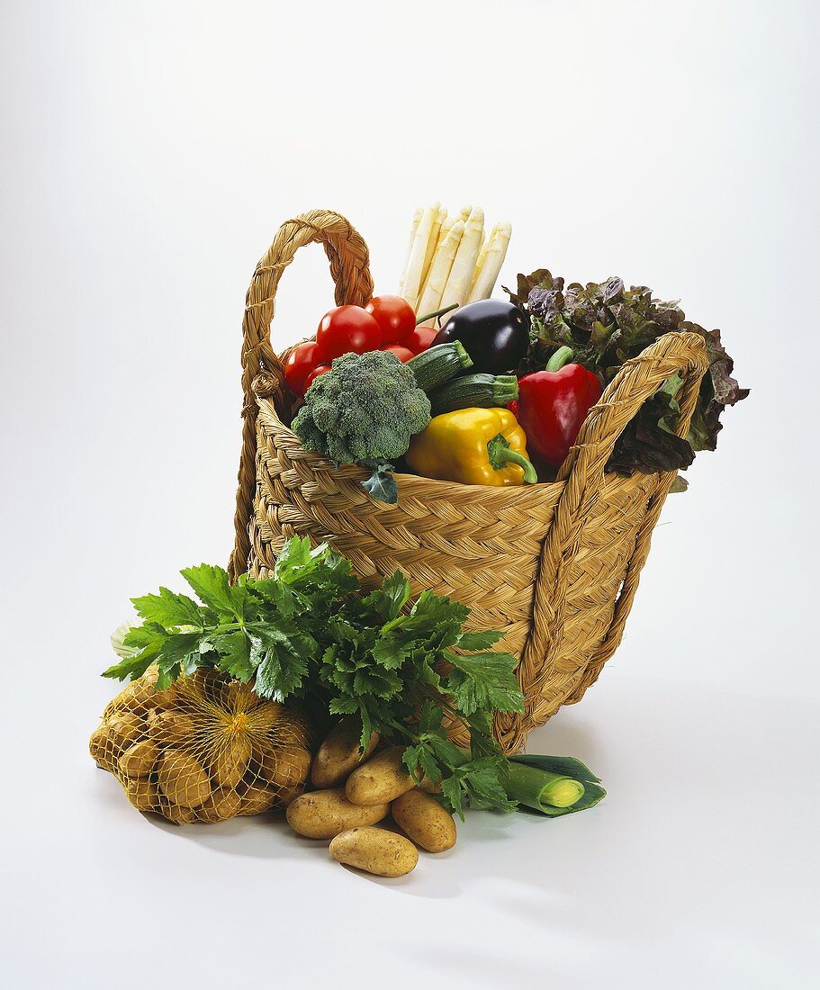 A Basket Full of Vegetables; Vegetables in front of Basket