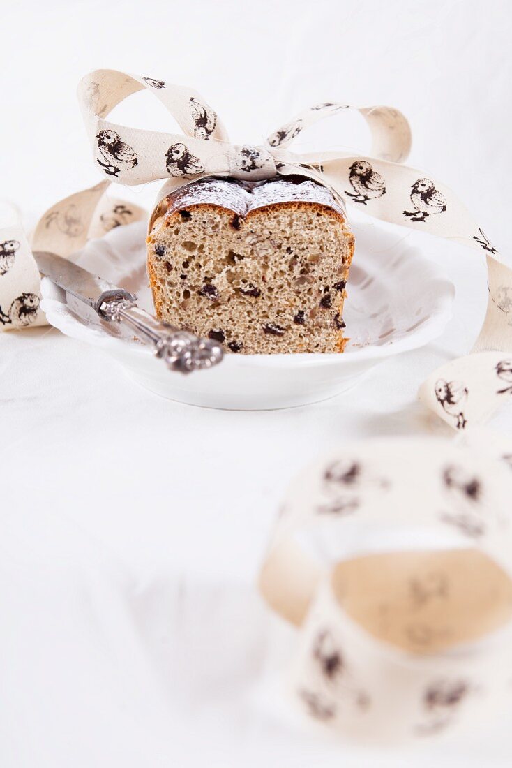 Easter bread with currants and pecans, decorated with ribbon