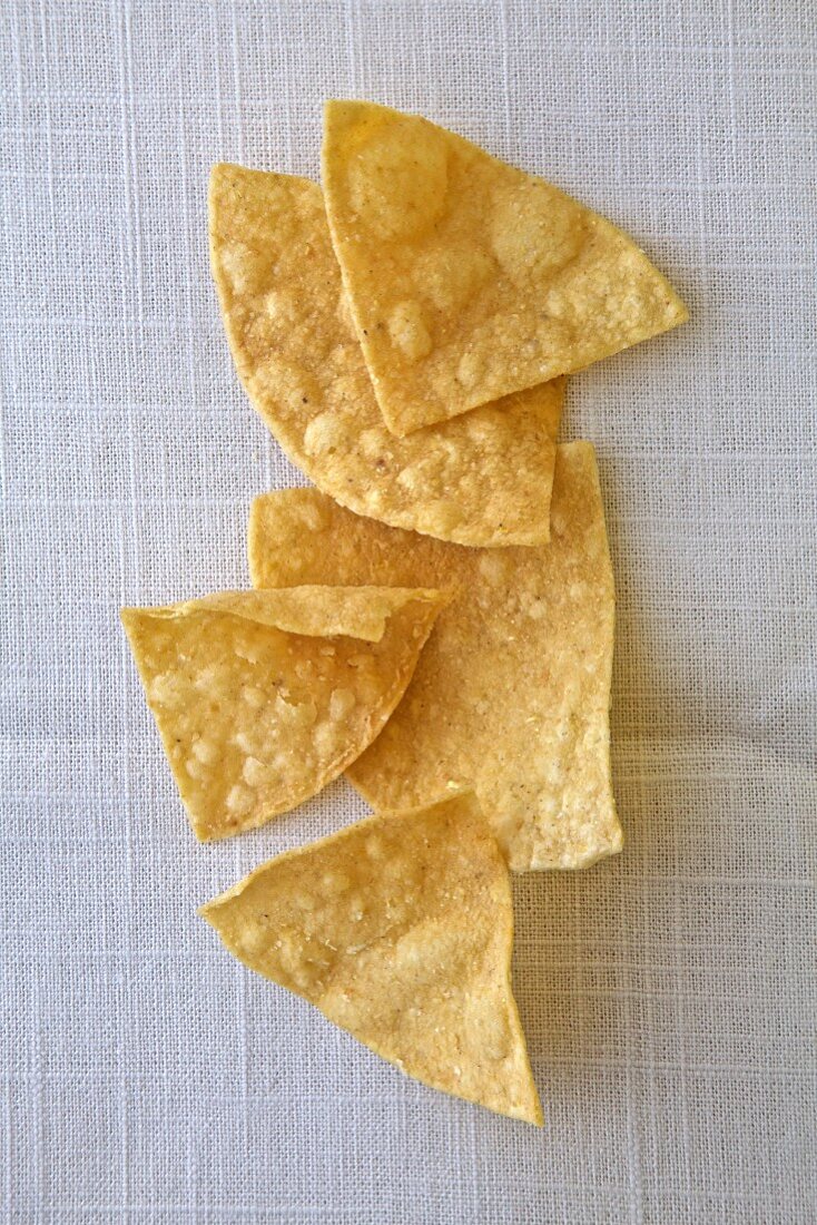 Several tortilla chips on a white background (top view)