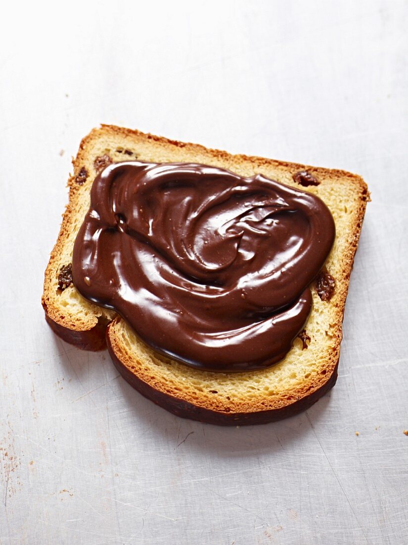 A slice of cake spread with nutella
