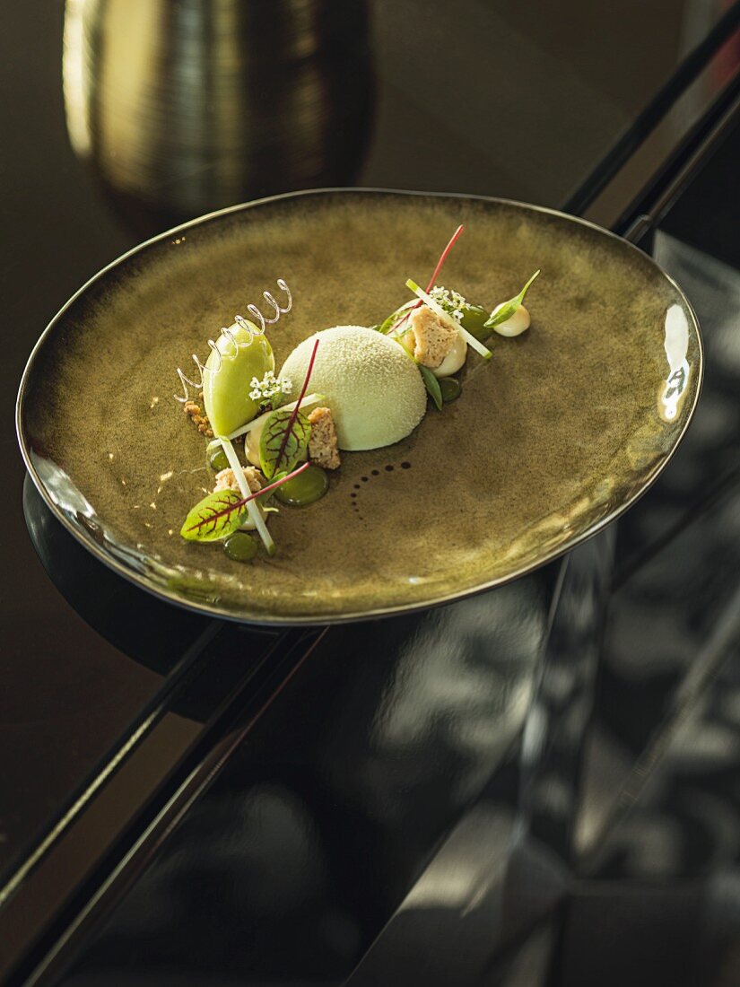 Granny Smith textures, buttered breadcrumbs, sake jelly and Goa biscuits by head chef Christian Sturm-Willms and his team at the 'Yunico' restaurant in Bonn, Germany