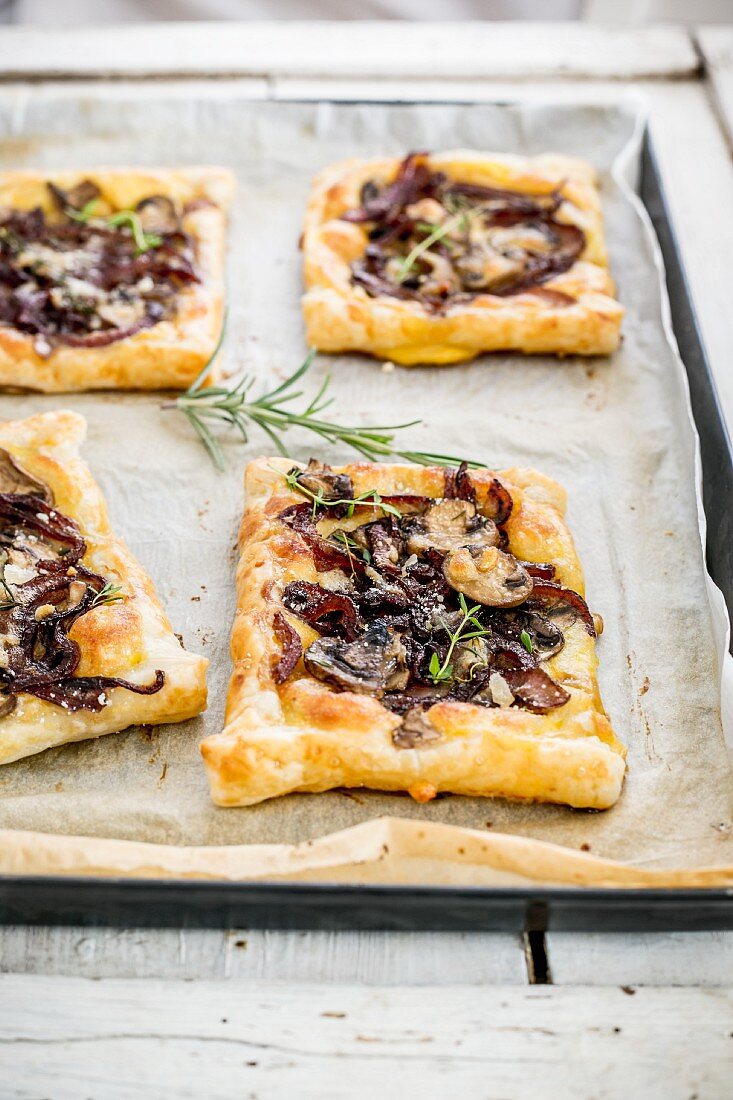 Pastries with caramelised onions, cheese and mushrooms