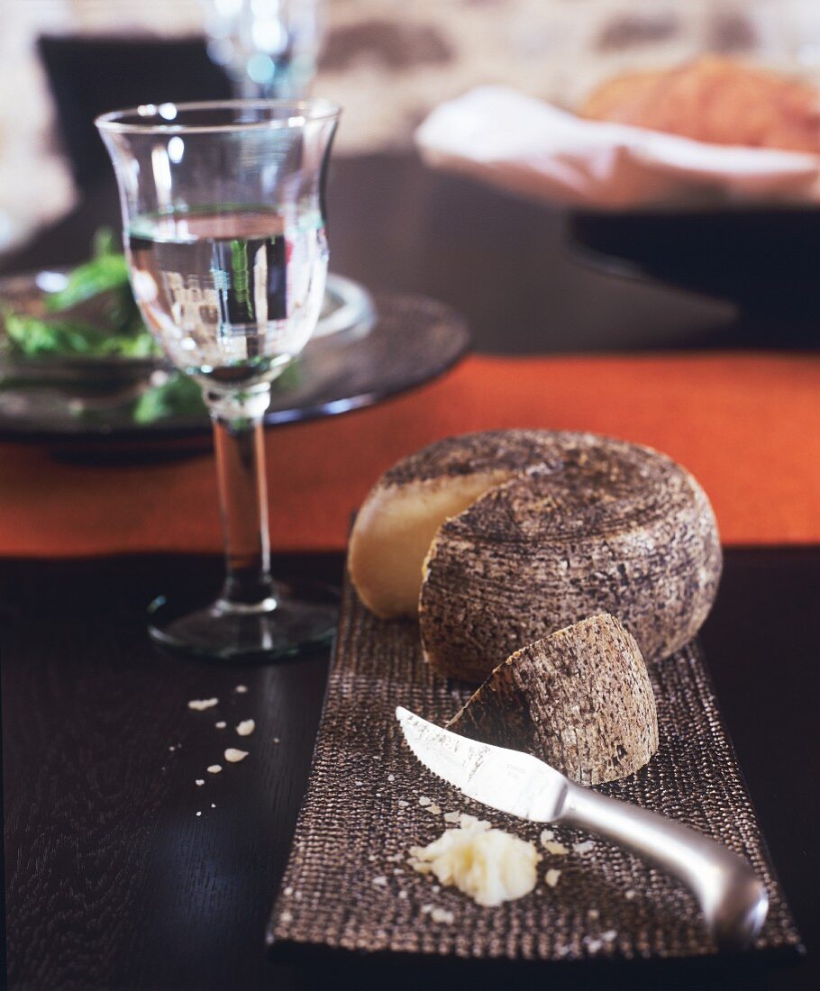 Cheese, knife and glass of water