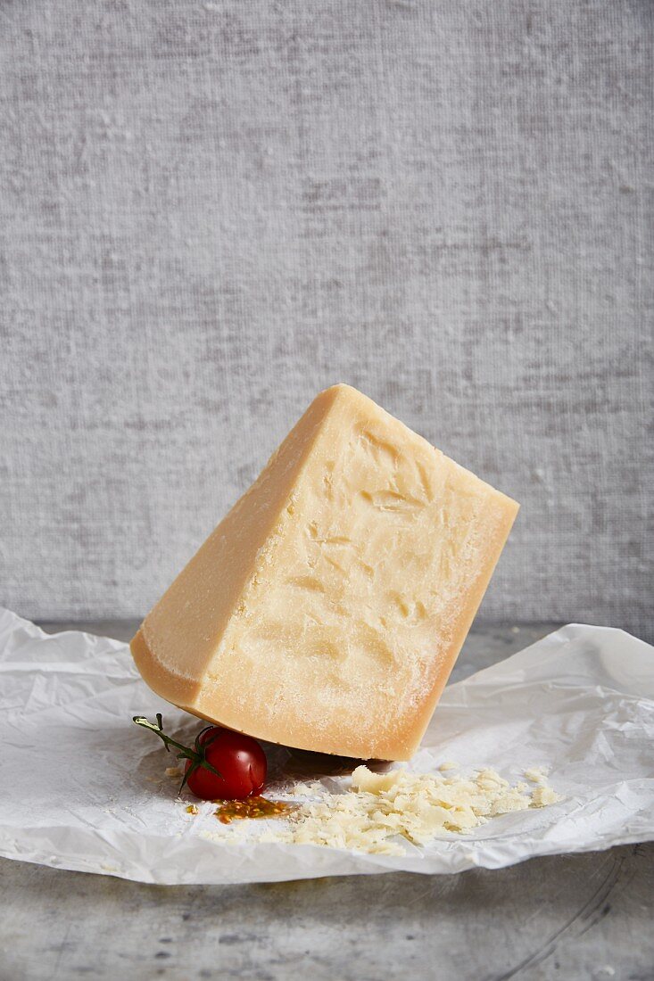 A wedge of parmesan cheese on paper