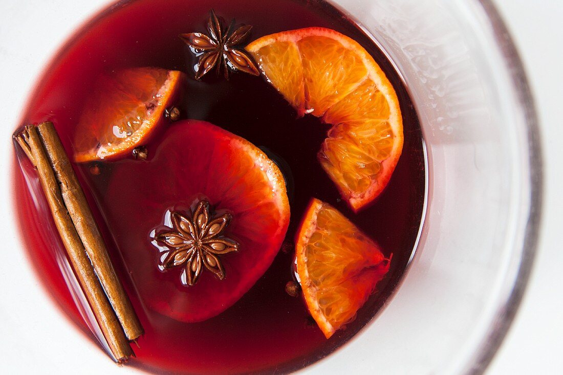 Mulled red wine with spices and fruit in a glass