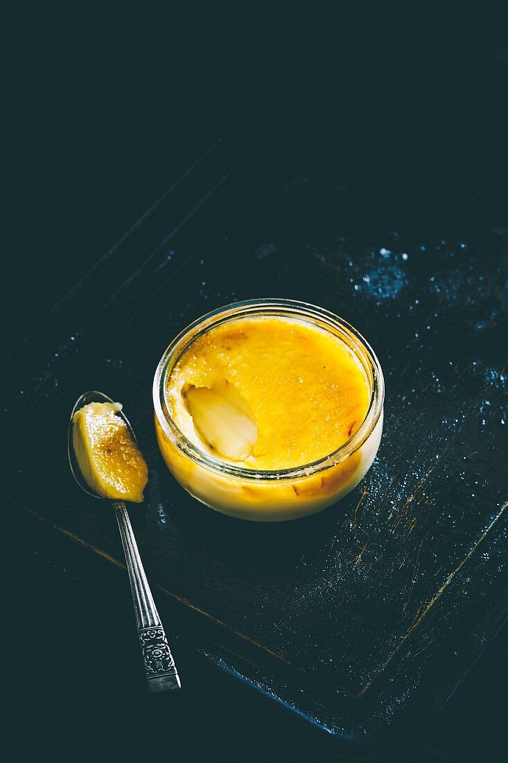 Creme brulee in a glass with a spoon