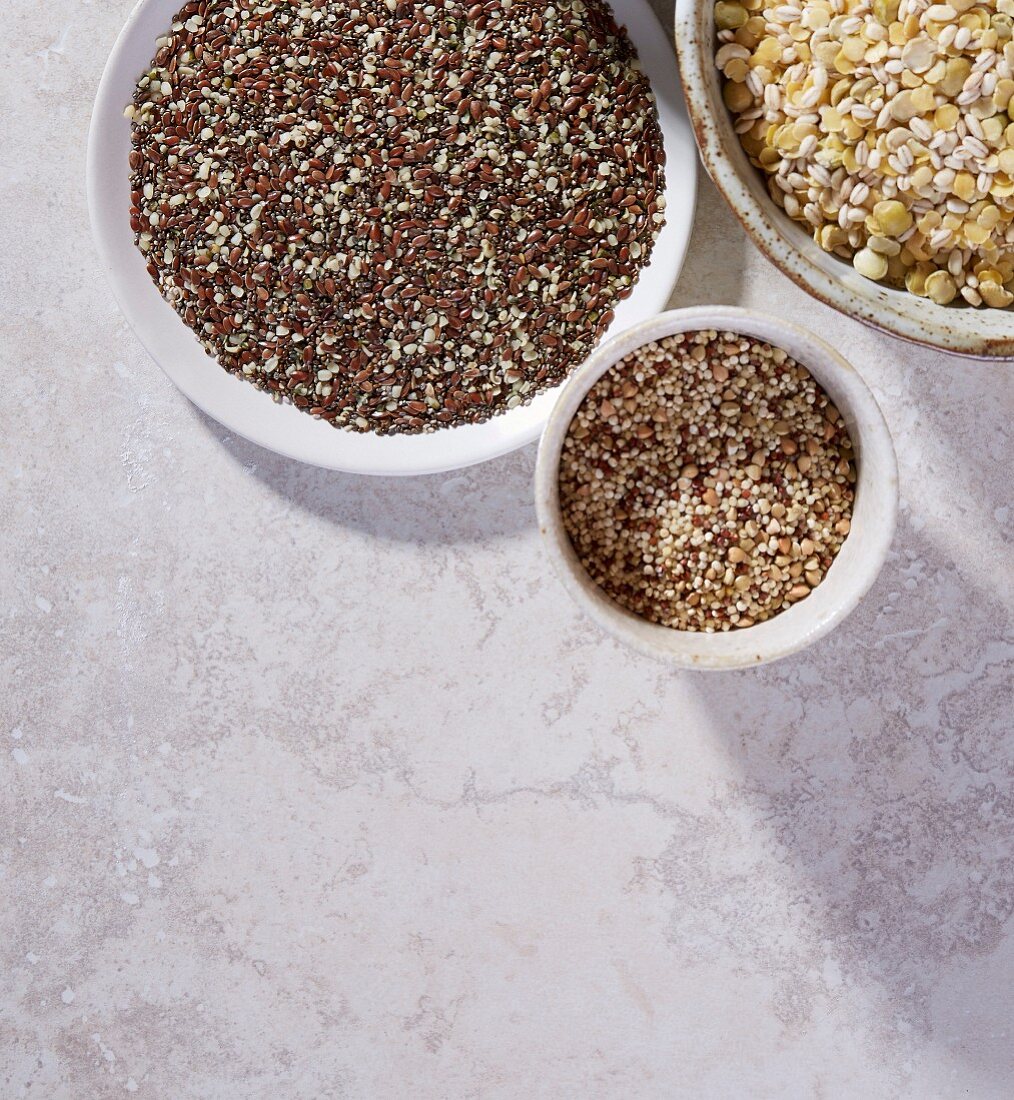 Linseed, quinoa, lentils and barley in bowls