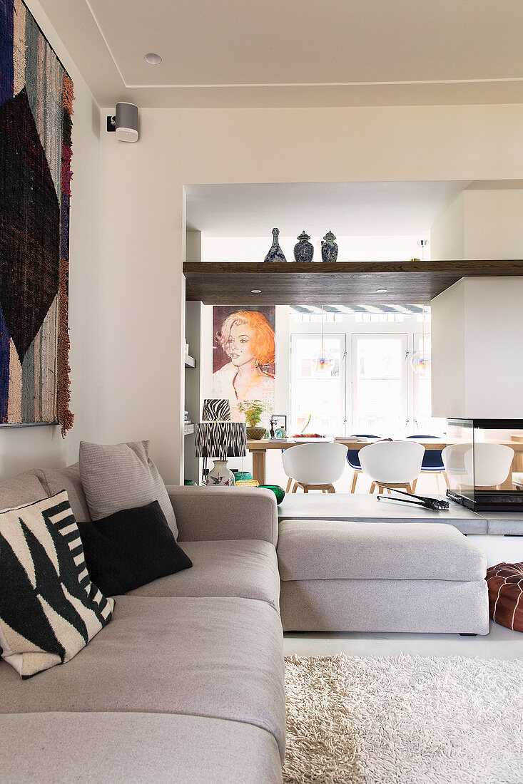 View across sofa though open doorway into dining room