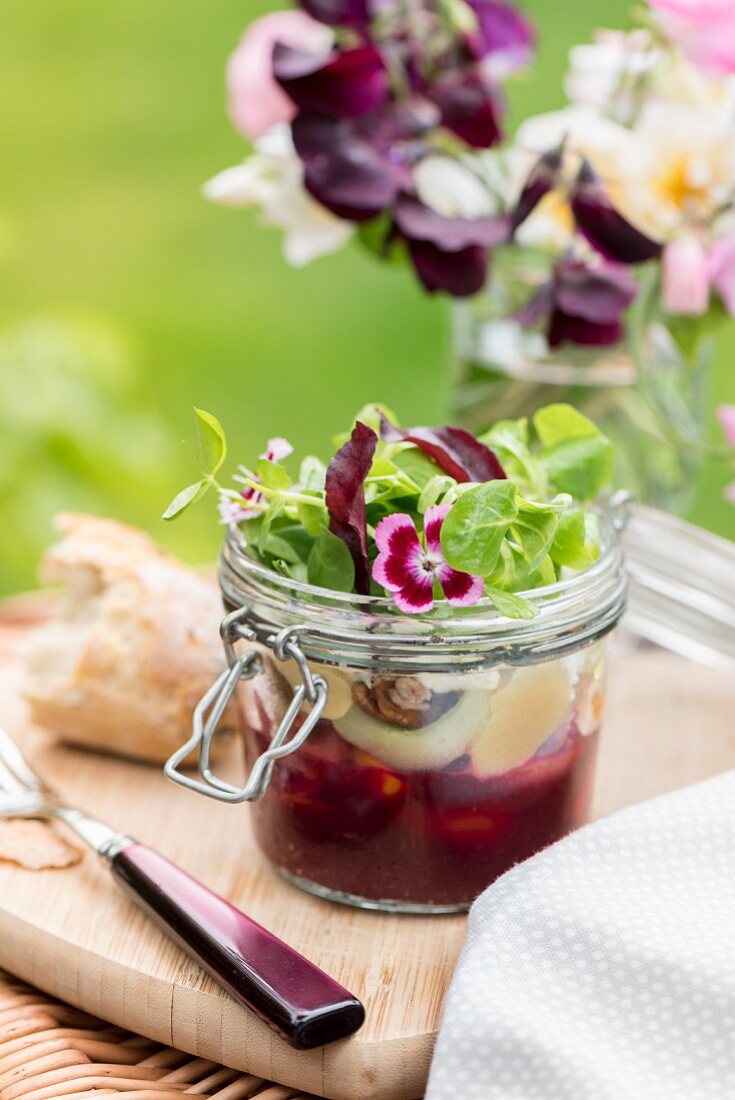 Salad with beetroot puree and marinated feta in glass jar for a picnic