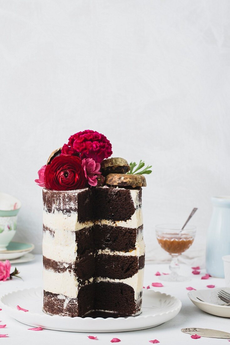 Wedding cake with buttercream, flowers, and gold donuts