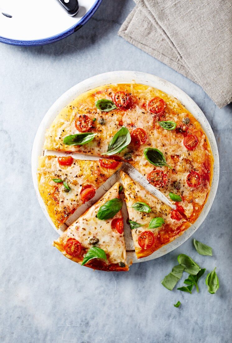 Cheese pizza with cherry tomatoes and capers