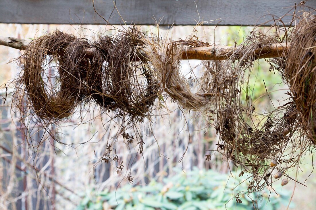 Hay wreaths hung from wooden pole