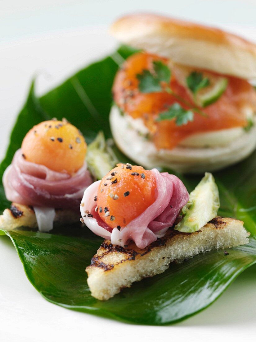 Smoked salmon roll with melon and parma ham canapes