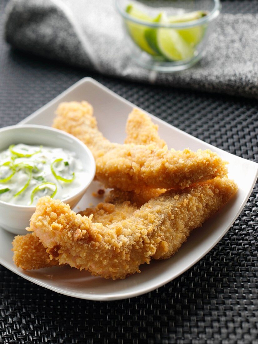 A plate of salmon goujons with dipping sauce