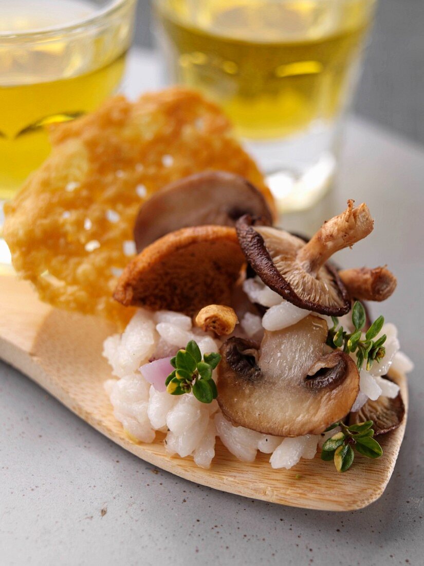 Wild mushroom risotto on a wooden spatula