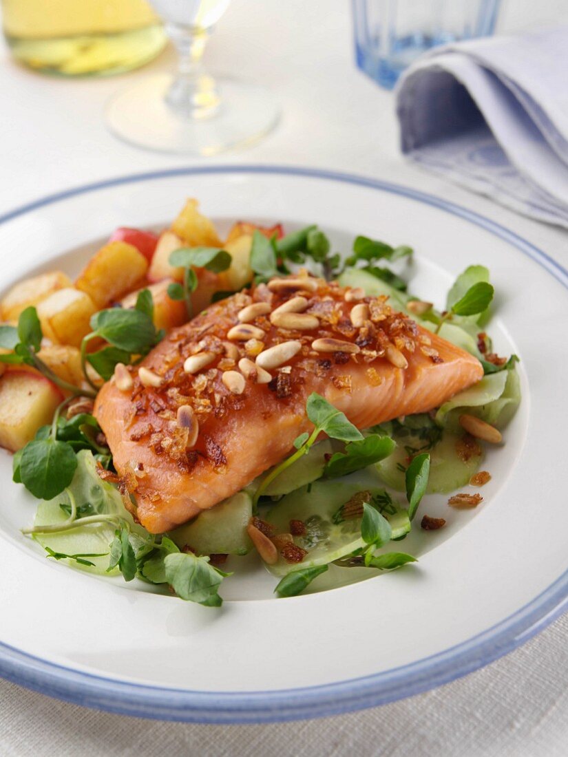 Single serving of smoked salmon tail with sauteed potatoes and apples editorial food