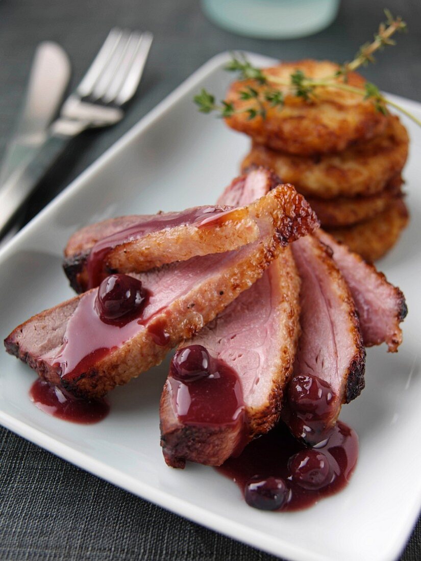 Roast duck with rosti potatoes and blackcurrant jus