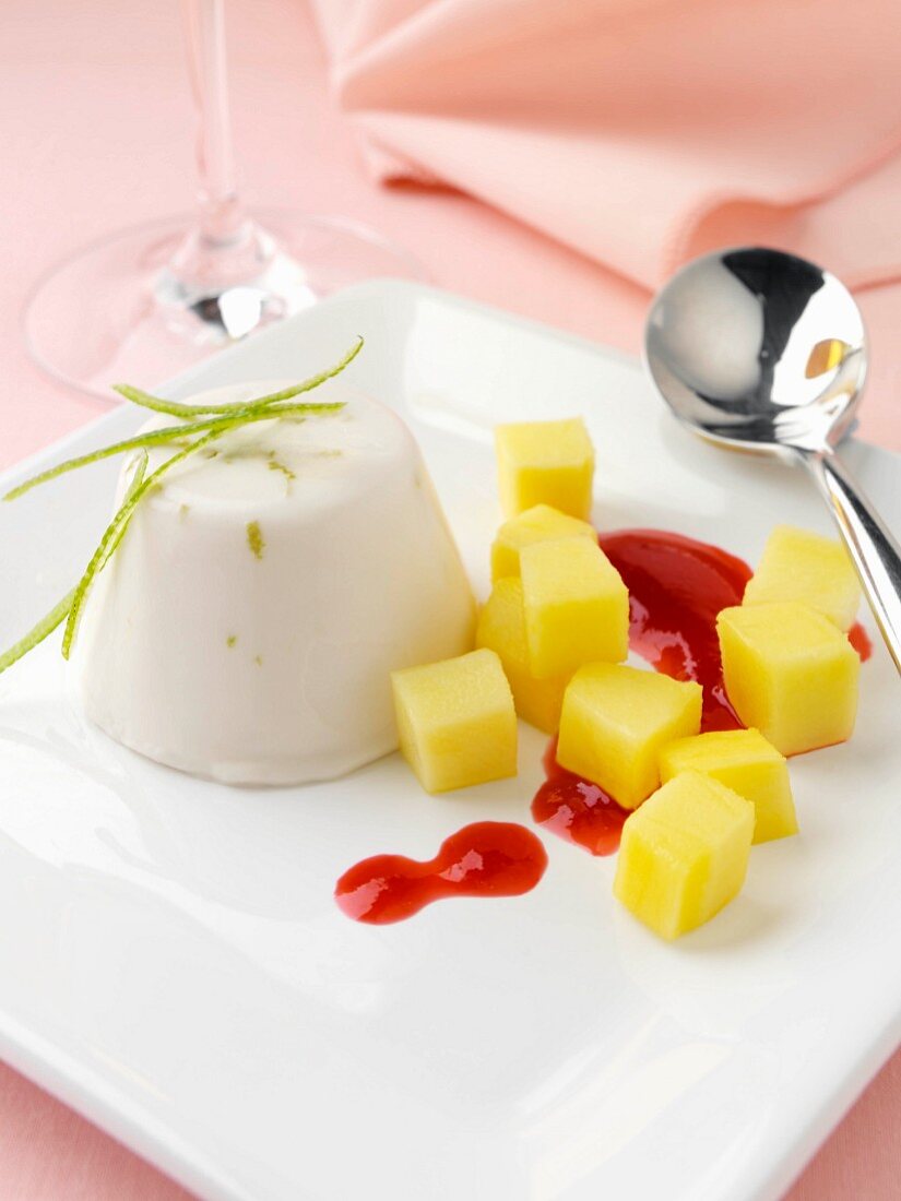 Lime and coconut panna cotta with raspberry coulis and mango pieces lactose and gluten freee