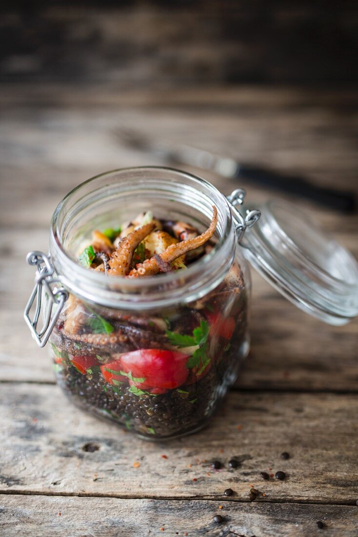 Lentil salad with octopus in a glass jar