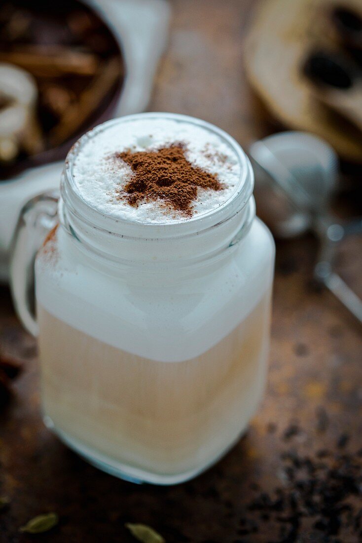 A chai latte decorated with a cocoa powder star