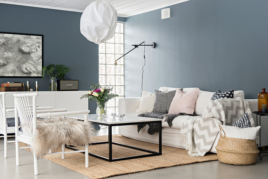 White chairs and coffee table in living room with grey walls