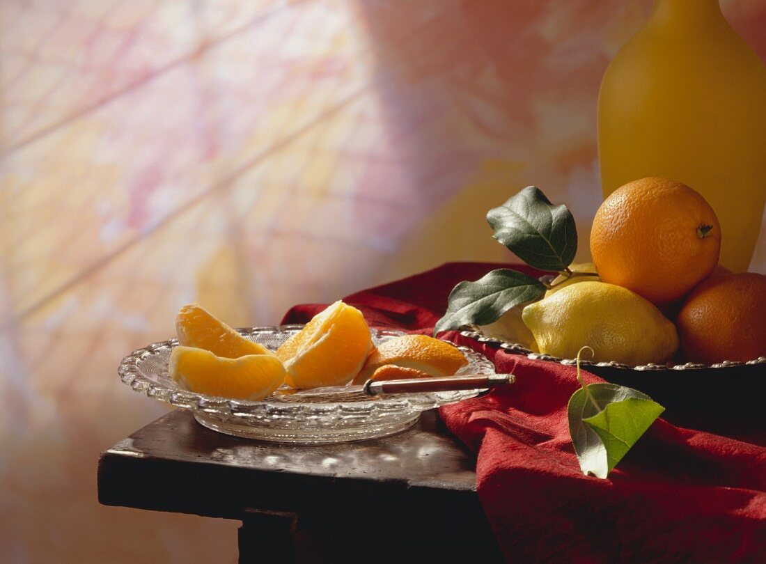 Peeled Orange on a Plate; Whole Oranges and Lemons in a Bowl