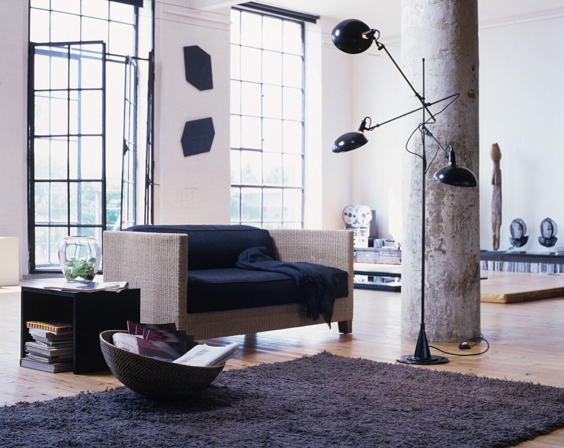 Modern living room in industrial loft apartment with metal windows