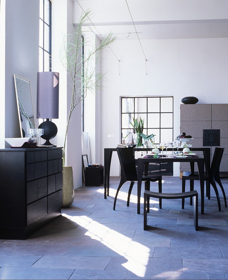 Black furniture in masculine dining room of loft apartment