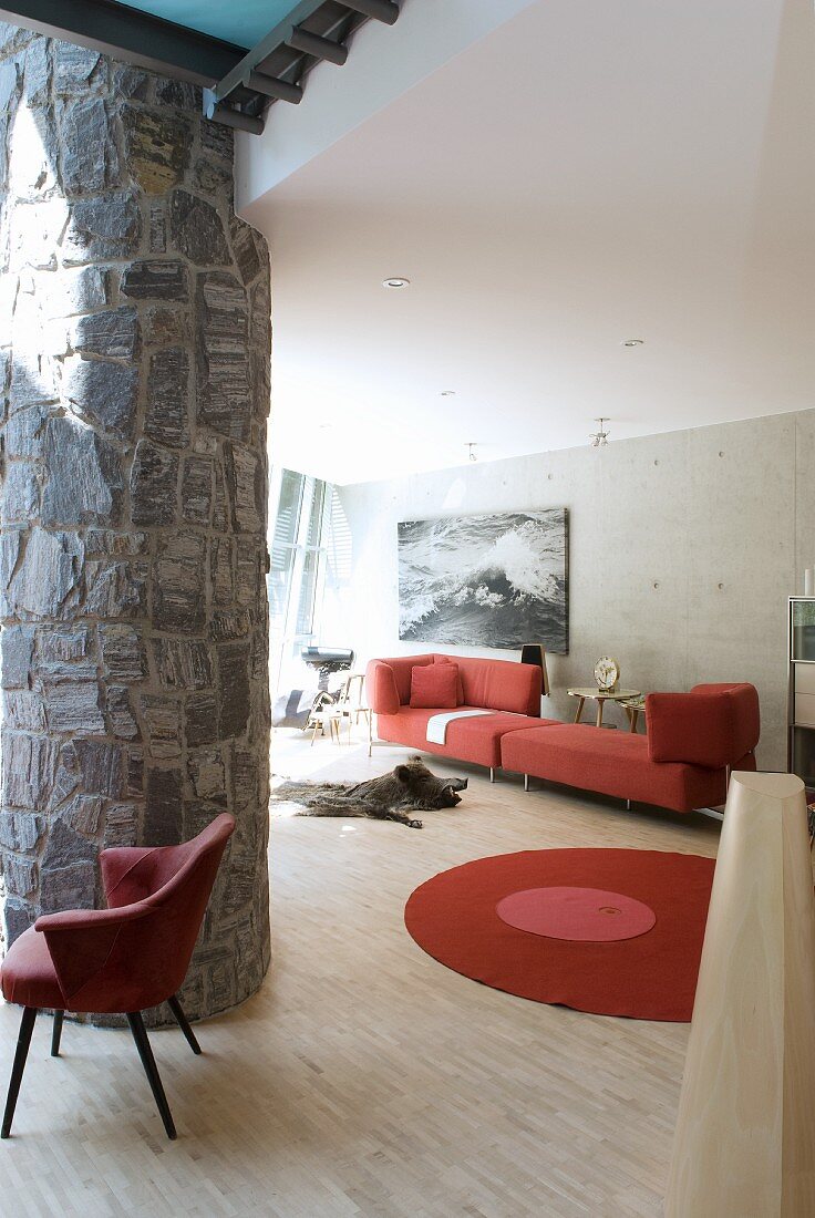 Stone column and red designer furniture in living room