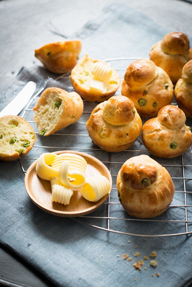 Brioches with butter curls on a wire cooling rack