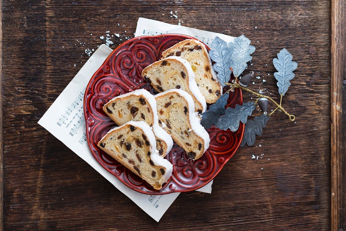 A sliced Christmas fruit loaf on a red plate