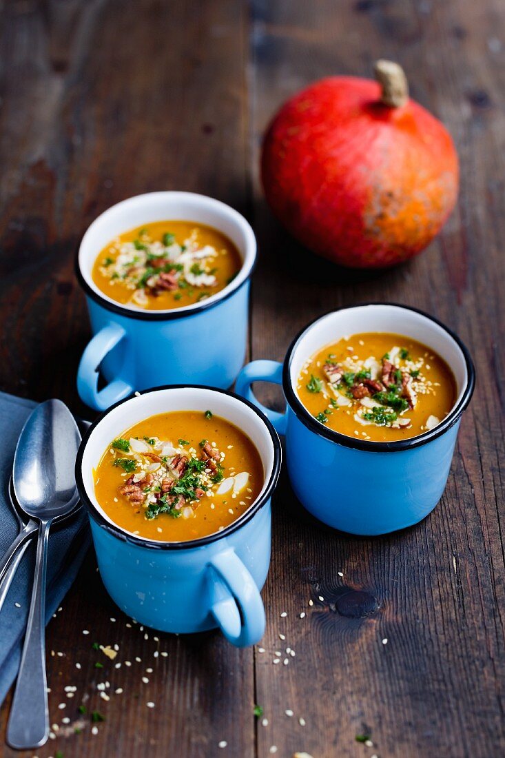 Pumpkin soup with pecan nuts, sesame seeds and almonds
