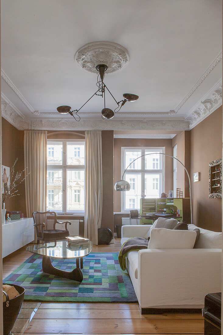 Brown walls and stucco ceiling in living room of period apartment