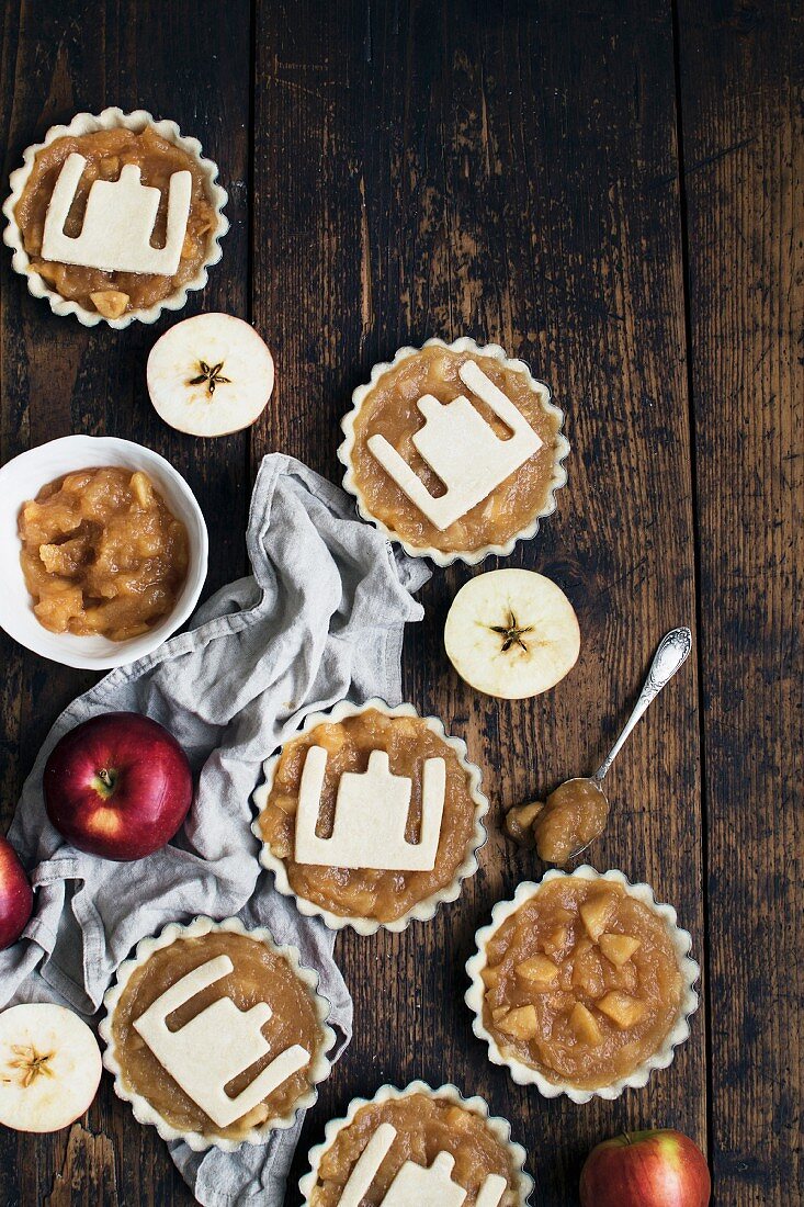 Unbaked apple tarts with a pastry pattern on the top