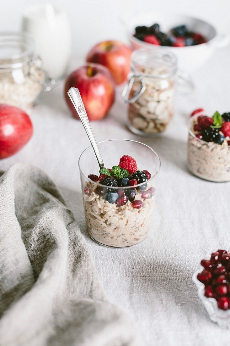 A clear glass of apple muesli topped off with berries