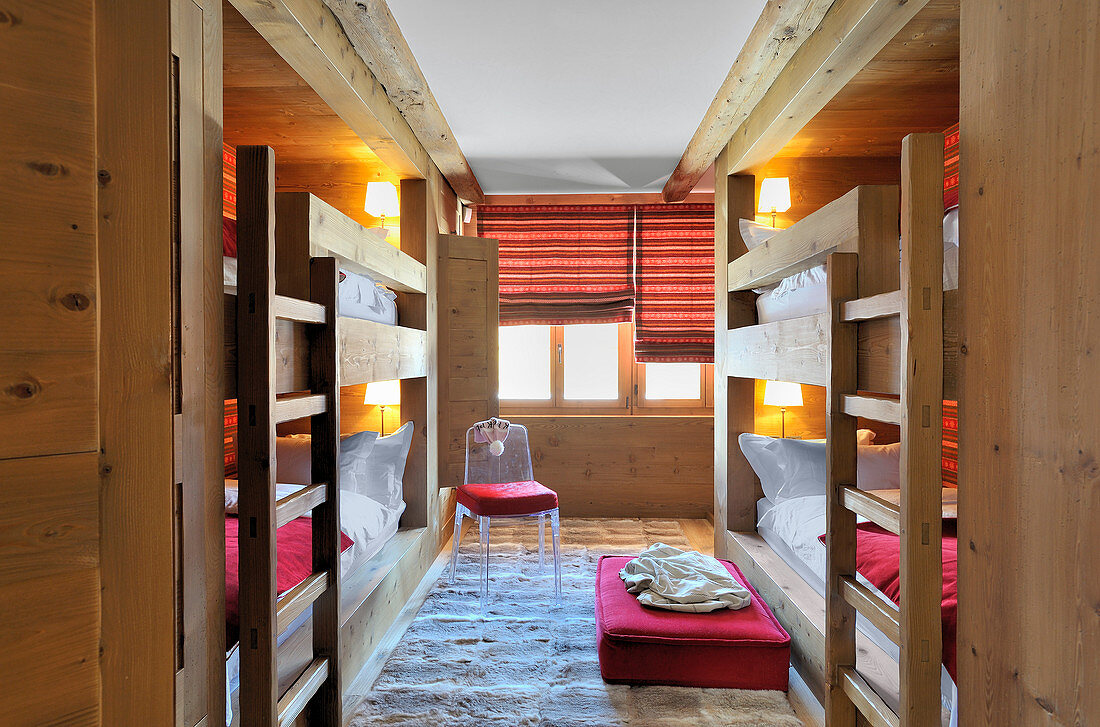 Two sets of wooden fitted bunk beds opposite on another