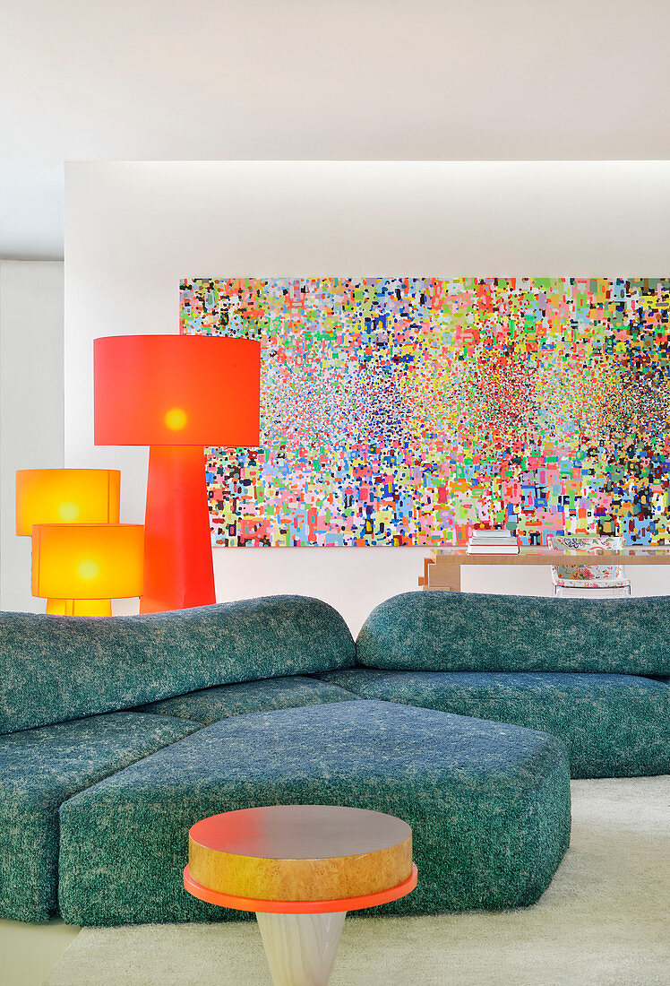 Blue sofa and colourful artwork in artistic living room