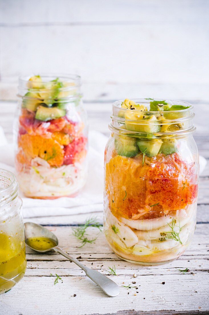 Fennel and orange salad with avocado and citrus vinaigrette in a glass jar
