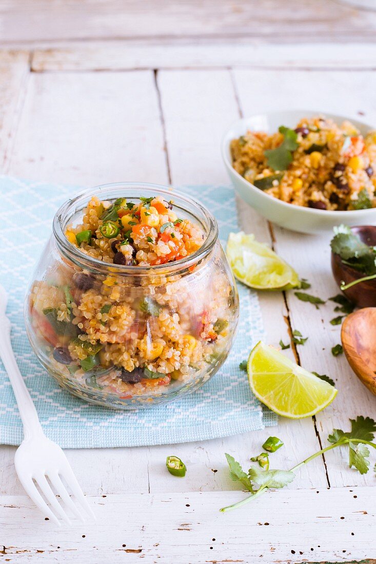 Mexican quinoa salad with coriander and lime in a glass jar