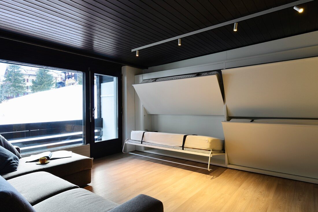 Multifunctional room with beds concealed in wall