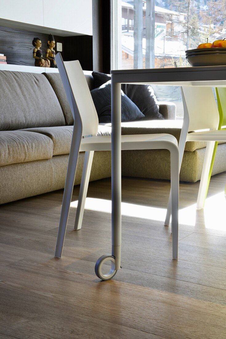 Dining table on castors in multifunctional room