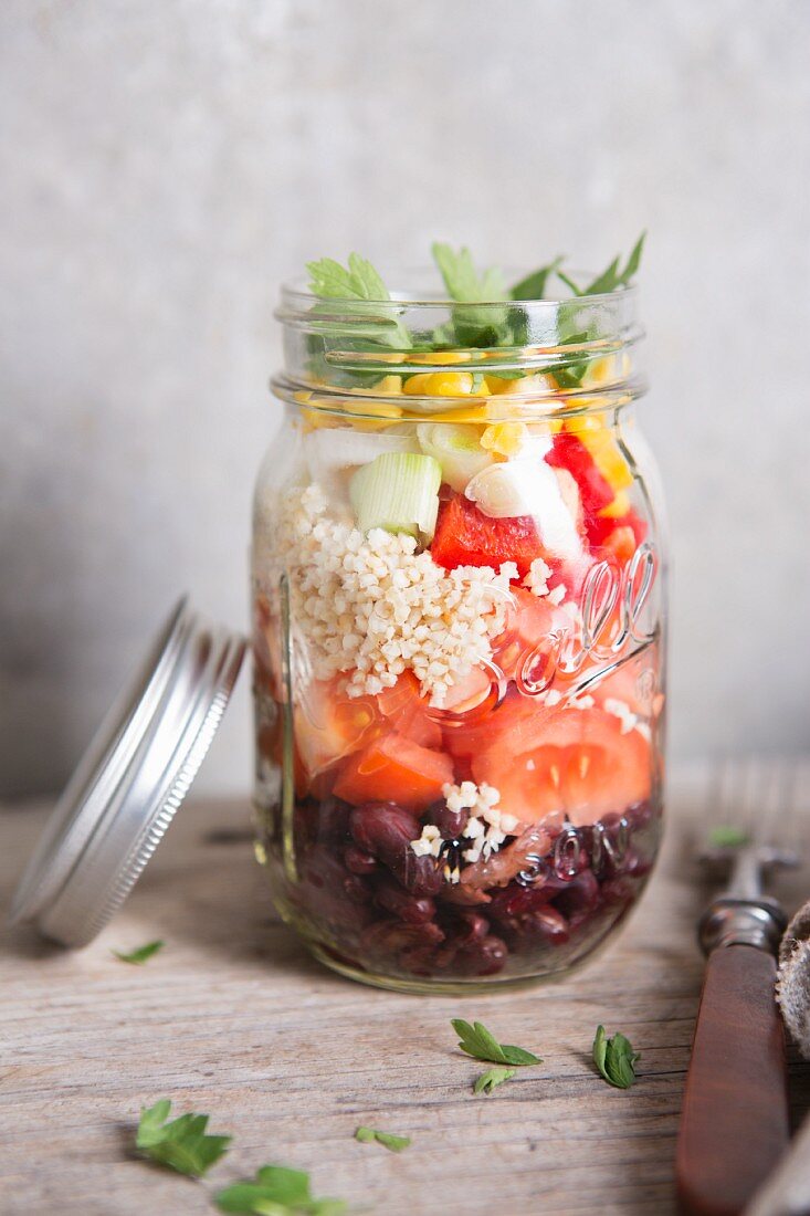 Quinoa salad with vegetables in a glass jar