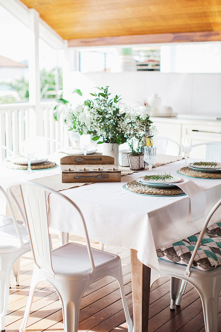 A table laid on a covered terrace