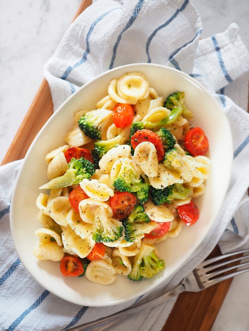 Orecchiette typical apulian pasta with cherry tomato Pachino broccoli and black pepper (Apuia, Italy)